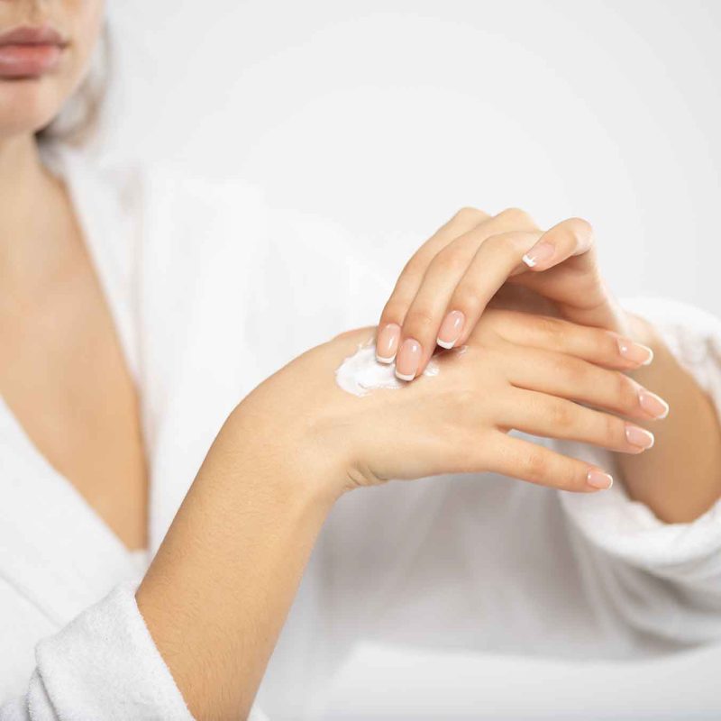 woman-applies-a-cosmetic-moisturizer-on-her-hands-SXDUKX3.jpg